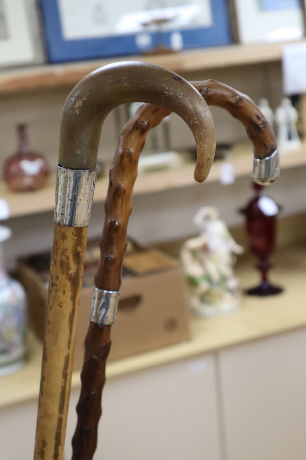 A copper stickstand shaped as a riding boot, height 52cm, two silver mounted walking sticks and a large brass jug, height 35cm